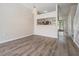 Open living room with wood-look floors and a clear view to the kitchen at 1308 Costa Mesa Dr, Wesley Chapel, FL 33543