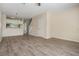 Open living space featuring wood-look floors and a view to the stairway at 1308 Costa Mesa Dr, Wesley Chapel, FL 33543
