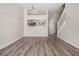 Open living area featuring wood-look floors and views of the kitchen and stairway at 1308 Costa Mesa Dr, Wesley Chapel, FL 33543