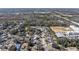 Community aerial view of single Gathering homes, baseball field, commercial properties and tree lined streets at 13215 Parkhurst Ct, Riverview, FL 33569