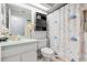 Bathroom with vanity, toilet, cabinet, mirror, and nautical-themed shower curtain at 13215 Parkhurst Ct, Riverview, FL 33569