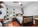 Cozy bedroom with playful decor, natural wood accents, and a ceiling fan for added comfort at 13215 Parkhurst Ct, Riverview, FL 33569
