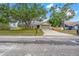 Charming single-story home with mature trees, a well-maintained lawn, and a long driveway at 13215 Parkhurst Ct, Riverview, FL 33569