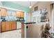 Kitchenette area featuring a breakfast bar, tile floors, wood cabinets, and granite countertops at 13215 Parkhurst Ct, Riverview, FL 33569