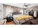 Spacious main bedroom with neutral walls, ceiling fan, and large bed with a tufted headboard and a decorative yellow throw at 13215 Parkhurst Ct, Riverview, FL 33569