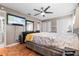 Main bedroom with parquet floors, ceiling fan, and a television on the wall at 13215 Parkhurst Ct, Riverview, FL 33569