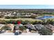 Panoramic aerial view of a residential area with houses, lush greenery, a golf course and scenic lakes nearby at 1330 Misty Greens Dr, Sun City Center, FL 33573