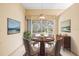 Cozy dining room with a round table, seating four, and a view of the outdoors, creating an inviting atmosphere at 1330 Misty Greens Dr, Sun City Center, FL 33573