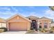 Charming single-story home featuring a two-car garage and a well-maintained front yard with beautiful landscaping at 1330 Misty Greens Dr, Sun City Center, FL 33573