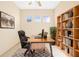 Bright home office with stylish desk, comfortable chair, and built-in shelves, ideal for a productive workspace at 1330 Misty Greens Dr, Sun City Center, FL 33573