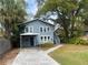 Charming two-story home with a covered entryway, brick path, and mature landscaping at 205 W Hilda St, Tampa, FL 33603