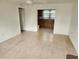 Open-concept living room with tile flooring and a ceiling fan, flowing into the kitchen at 205 W Hilda St, Tampa, FL 33603