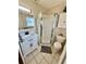 Bathroom featuring a vanity with marble countertop, a framed mirror, and a corner shower with glass doors at 2533 Duncan Dr, Belleair Bluffs, FL 33770