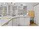 Bright bathroom with a double vanity, neutral tiling and a framed mirror at 2765 Via Cipriani # 1232B, Clearwater, FL 33764