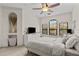 Well-lit bedroom featuring a ceiling fan, a triple window, and a decorative alcove at 2765 Via Cipriani # 1232B, Clearwater, FL 33764