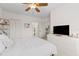 Bright bedroom with white linens, a dresser and a view of the ensuite bathroom at 2765 Via Cipriani # 1232B, Clearwater, FL 33764