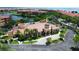 Stunning clubhouse featuring a dome and tile roof, surrounded by lush landscaping and a pool, near the waterfront at 2765 Via Cipriani # 1232B, Clearwater, FL 33764