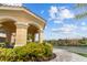 Charming outdoor gazebo and beautiful waterfront view with palm trees and colorful flowers in a waterfront community at 2765 Via Cipriani # 1232B, Clearwater, FL 33764