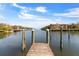 Picturesque view from a wooden dock, overlooking calm waters with buildings on the horizon creating a tranquil waterfront scene at 2765 Via Cipriani # 1232B, Clearwater, FL 33764