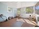 Enclosed patio with bike and cat tree, ideal for workouts and relaxation at 3108 Ash Ct, Dunedin, FL 34698
