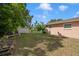 Expansive backyard with a storage shed, lush lawn, and ample space for outdoor activities at 651 Southwest N Blvd, St Petersburg, FL 33703