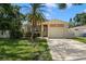 Charming single-story home with a well-maintained lawn, mature landscaping, and an attached garage at 651 Southwest N Blvd, St Petersburg, FL 33703