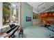 Bright lobby featuring a grand piano, colorful mosaic wall with TV, and comfortable seating area at 777 N Ashley Dr # 2503, Tampa, FL 33602