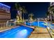 Night scene featuring a rooftop pool and hot tub with illuminated water and skyline views at 777 N Ashley Dr # 2503, Tampa, FL 33602