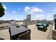 Stylish rooftop deck with a dining table, comfortable seating, and panoramic city views at 777 N Ashley Dr # 2503, Tampa, FL 33602