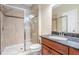 Bathroom features a walk-in shower with tile surround and a dark vanity with granite counters at 12537 Silverdale St, Tampa, FL 33626