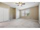 A primary bedroom featuring neutral paint, plush carpet, two closets, and two windows at 12537 Silverdale St, Tampa, FL 33626