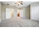 A primary bedroom featuring neutral paint, plush carpet, two closets, and three doors that lead to other rooms at 12537 Silverdale St, Tampa, FL 33626