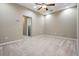 Spacious carpeted bedroom with a ceiling fan and neutral paint, offering a bright and airy feel at 12537 Silverdale St, Tampa, FL 33626