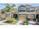 Townhome featuring a two-car garage, stucco walls, and a decorative balcony at 12537 Silverdale St, Tampa, FL 33626