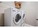 Laundry room featuring a white GE washer and dryer with a wire shelf at 12537 Silverdale St, Tampa, FL 33626