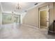 Open floor plan with tile flooring, ceiling fan, stairs, and sliding glass doors to the outside at 12537 Silverdale St, Tampa, FL 33626