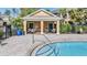 Community pool house with tables and chairs next to the community pool at 12537 Silverdale St, Tampa, FL 33626