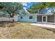Backyard of home with a white fence and green and leafy trees at 13851 102Nd Ave, Largo, FL 33774