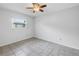 This serene bedroom features tiled floors, a ceiling fan, and window for natural light at 13851 102Nd Ave, Largo, FL 33774