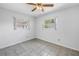 Spare bedroom showcases tile floors, a ceiling fan, and windows for plenty of natural light at 13851 102Nd Ave, Largo, FL 33774