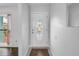 Bright entryway featuring a decorative glass front door and neutral tile flooring at 13851 102Nd Ave, Largo, FL 33774
