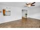 Open floorplan living room features wood-look floors, a ceiling fan, and a view of the kitchen at 13851 102Nd Ave, Largo, FL 33774