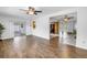 Open-concept living room with wood-look floors offering views of the kitchen and screened-in porch at 13851 102Nd Ave, Largo, FL 33774