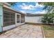 A brick patio next to a screened-in porch with a view of the white vinyl fence at 13851 102Nd Ave, Largo, FL 33774