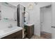 Bathroom with dual vanities, mirrors and modern fixtures at 20 Sylvia Pl, Oldsmar, FL 34677
