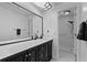 Bathroom with black vanity, white countertops and a walk-in shower at 20 Sylvia Pl, Oldsmar, FL 34677