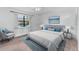 Bright bedroom featuring a large bed, chair, and neutral décor, creating a serene and inviting space at 20 Sylvia Pl, Oldsmar, FL 34677