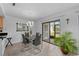 Dining area with sleek table, modern lighting, tile floors, and slider to porch at 20 Sylvia Pl, Oldsmar, FL 34677