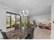 Bright dining area with sliding glass doors to patio, modern lighting, and neutral decor at 20 Sylvia Pl, Oldsmar, FL 34677