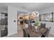 Dining area with modern light fixture, and marble-look table and chairs at 20 Sylvia Pl, Oldsmar, FL 34677
